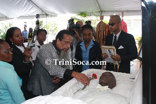 Edwin 'Crazy' Ayong places a rose next to Mighty Duke's body