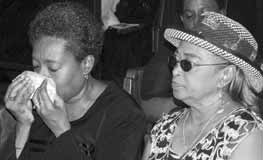 Grieving wife PAT BIRCH (left) drying her eyes.